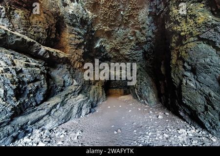 Tunnel excavated in volcanic rocks at rear of a sea cave in the Black Cove / Caleta Negra, Natural Monument of Ajuy (Peurto de la Pena), Fuerteventura Stock Photo