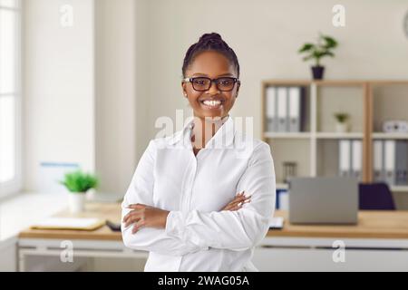 African American businesswoman standing confidently with her arms folded Stock Photo