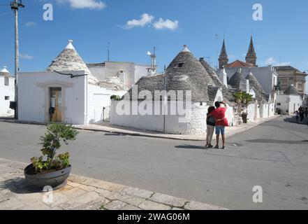 Tourists visit the city of Alberobello,Trulli houses are a UNESCO World Heritage Site Puglia, Italy Stock Photo