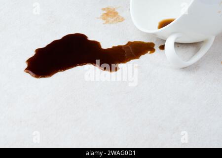 Spilled coffee on the upholstery of the couch or carpet. dirty stains in daily life for cleaning concept. Stock Photo
