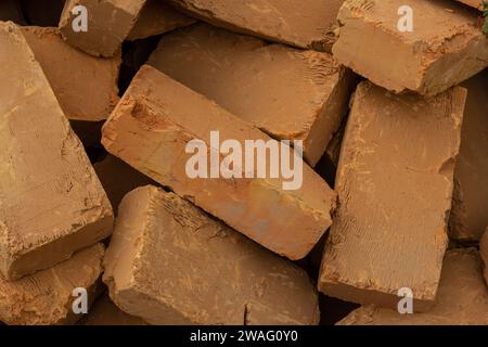 Solid clay brick used for construction. Background, brown red color. Stock Photo