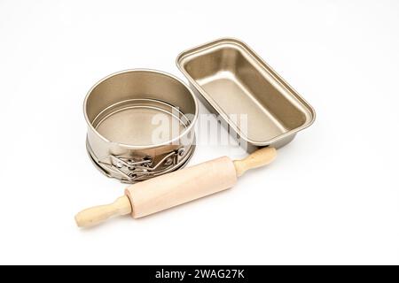 Baking forms for cake with Wooden rolling pin on white background Stock Photo