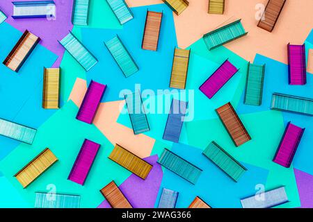Multicolored office metal staples for stapler on multicolored paper Sticky Notes Stock Photo
