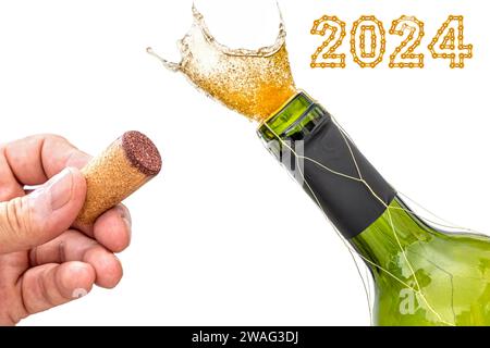 Opening of wine bottle isolated against white with hand holding the stopper by the neck of bottle with 2024 Happy New Year made from chain links Stock Photo