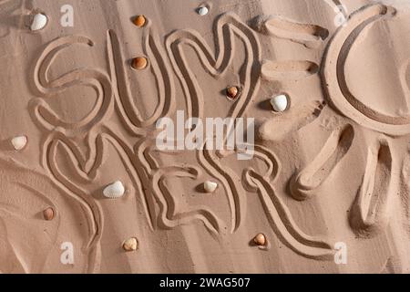 Beach sand background. Sand texture with seashells and inscription summer , vacation concept, abstract background for design, Top view. Stock Photo