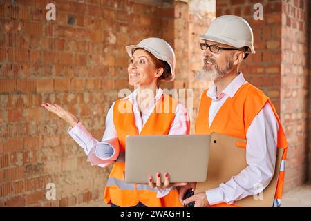 Construction supervisor showing something to foreman about the building Stock Photo