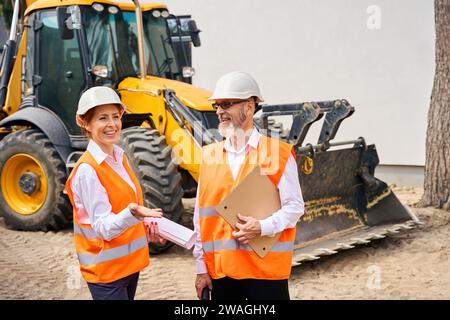 Team of construction professionals inspecting together building site Stock Photo