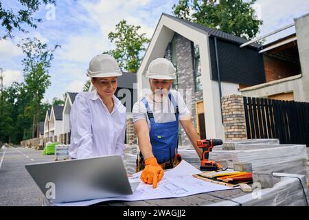 Building experts studying together site development plans Stock Photo