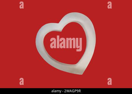 White cutout of a heart shows shadows and 3D dimension. Inner heart is plain with or without your text. Contrast small amount of white with most red. Stock Photo