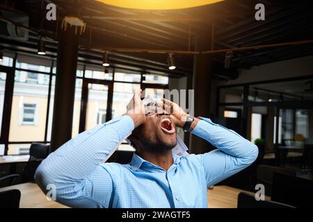 Angry African American supervisor screaming, having problems in business Stock Photo