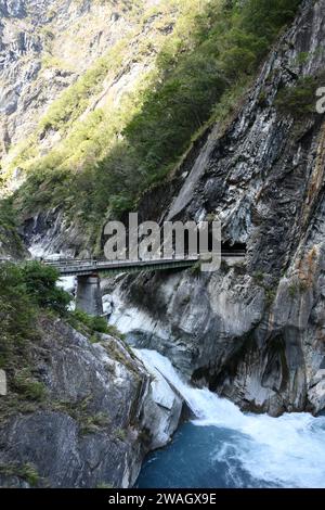 Vertical shot of the Ice blue river and the bridge over it in Tianxiang, Hualien, Taiwan Stock Photo