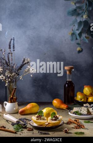 Ripe pears with nuts and blue cheese with maple syrup surrounded by ingredients on light gray background. Stock Photo