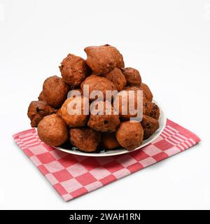 Bowl of oliebollen on a red checkered kitchen towel Stock Photo