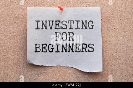 a scrap of paper with INVESTING FOR BEGINNERS written on it Stock Photo