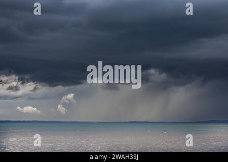 dark rain cloud with heavy rain passing over the Chiemsee, Germany, Bavaria, Lake Chiemsee Stock Photo