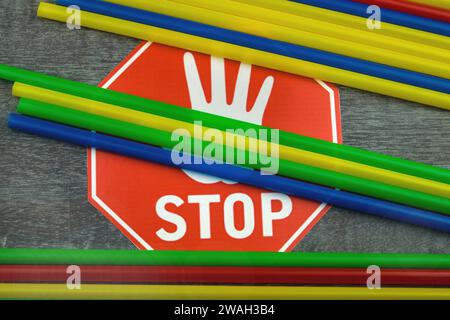 colorful plastic straws on stop sign Stock Photo