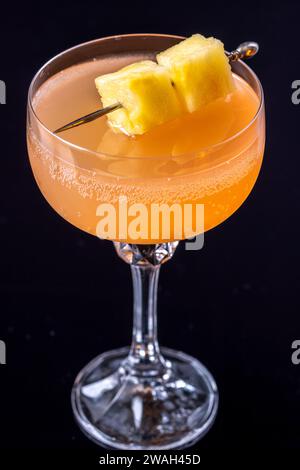 Only fans Martini cocktail garnished with pineapple cubes Stock Photo