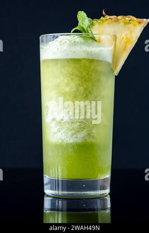 Missionary's Downfall cocktail garnished with pineapple wedge Stock Photo