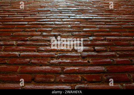 The red brick wall seen from below shows light from above Stock Photo
