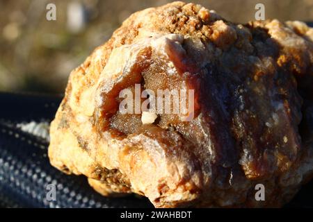 Reddish chalcedony on the surface of agate secretion after washing with water Stock Photo