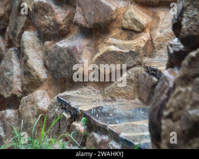 Rain falling on stone steps Stock Photo