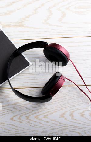 Pen, notebook and headphone on wooden texture background Stock Photo