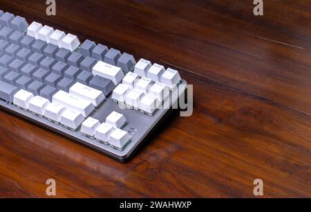 A modern mechanical keyboard on a wooden table. After some edits. Stock Photo