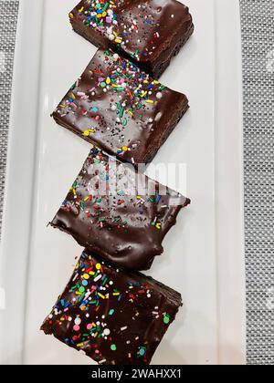 Sliced frosted and decorated chocolate brownies ready to be served Stock Photo