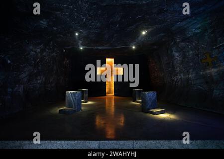 Illuminated cross representing stations of the cross, illustrate the events of Jesus last journey glows with spiritual light in the underground Catedr Stock Photo