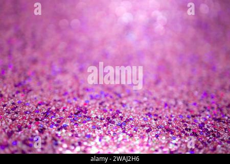 Defocused shimmering pink glitter texture background with vibrant color and bokeh Stock Photo