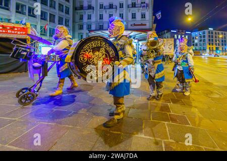 Lucerne, Switzerland - February 20, 2023: Band of musicians in costumes march in the streets, part of an early morning parade of the Fasnacht Carnival Stock Photo