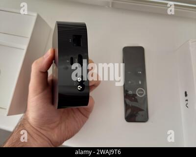 A closeup of an Apple TV remote controller on a white windowsill Stock Photo