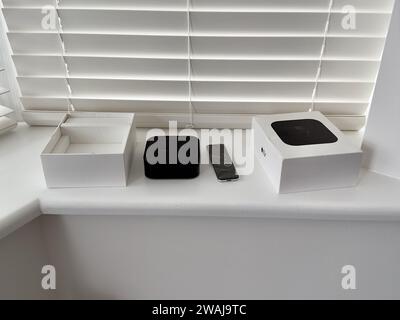 A closeup of an Apple TV remote controller on a white windowsill Stock Photo