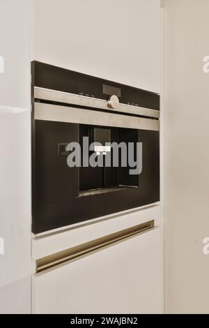 White door of modern refrigerator with water dispenser in kitchen at home Stock Photo