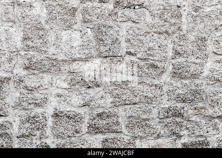 Old light gray stone wall background. Closeup front view of stone wall texture Stock Photo