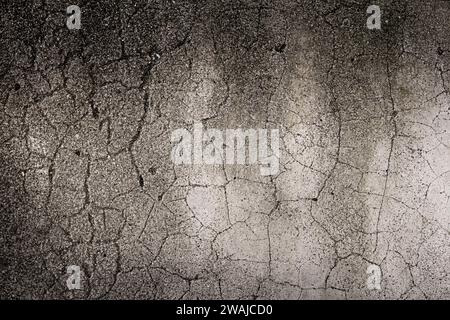 Cracked concrete wall background. Aged dark gloomy wall Stock Photo