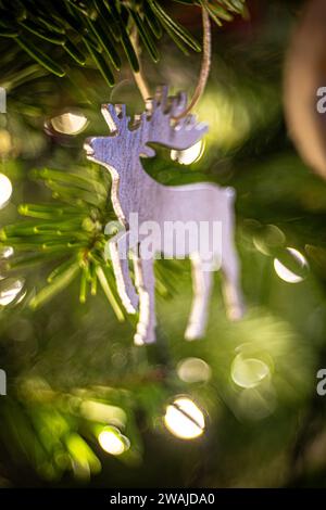 A white deer ornament on a festive Christmas tree Stock Photo