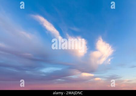 Beautiful wispy clouds with pink and blue background Stock Photo