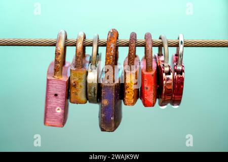 Love locks on a wire rope in a row. Objects in close-up Stock Photo