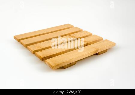 Traditional  hard wood constructed hot pan trivet isolated on a white background Stock Photo
