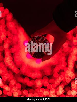 Light tunnel illuminated red as seen through red crystal ball Stock Photo