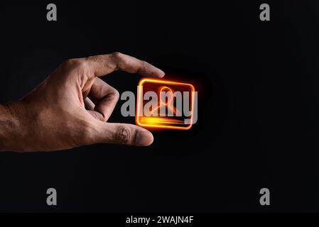 Closeup image of hand and digital identification card or digital ID on black background. Technology concept. Stock Photo