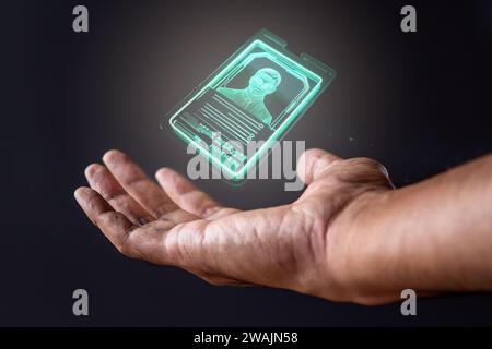 Closeup image of hand and digital identification card or digital ID on black background. Technology concept. Stock Photo