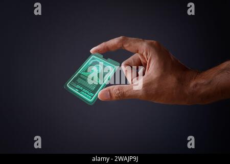 Closeup image of hand and digital identification card or digital ID on black background. Technology concept. Stock Photo