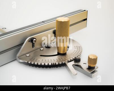 Close up of the Knurled Brass handles Steel precision  table saw mitre gauge iwith fence solated on a white background Stock Photo