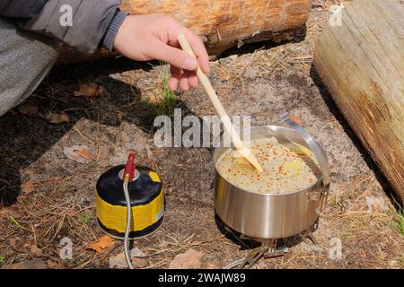 Traveler foods in outdoor activities. Camping food making. Food in bowler in forest. Stock Photo