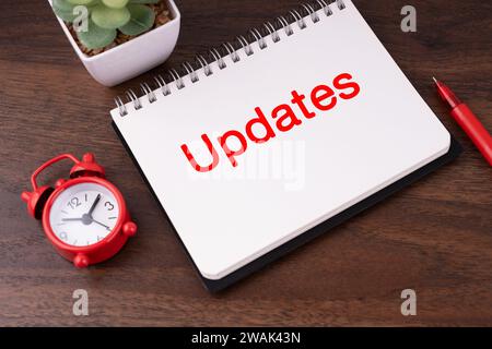 Updates text on notepad flat lay Stock Photo