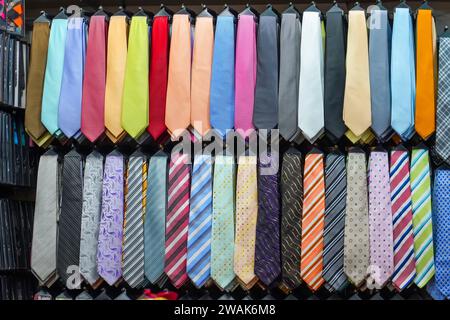 Many different ties of multi colors on display at the exhibition showcase. Large assortment of items for customers to choose from. Stock Photo