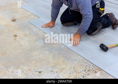 Installation of laminate flooring in new home by man Stock Photo