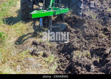 Preparation of land for sowing in spring season by farmer in tractor Stock Photo